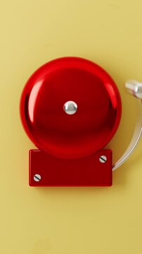 Close up of red school alarm bell on golden background