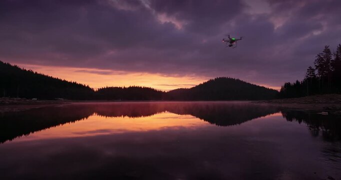 Drone flying over Shiroka Polyana dam lake during sunrise in Rhodope Mountains Bulgaria