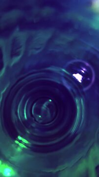 Futuristic 4k footage in teal colour with reflections in blue tones .Space for text.Vertical video with transparency .Abstract moving light flashes