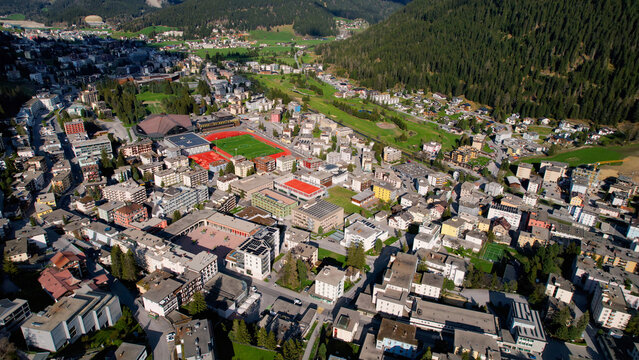 Aerial panoramic view above the downtown around the city Davos in Switzerland on a sunny summer afternoon. 