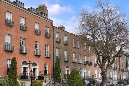 Long row of plain brick Georgian style townhouses