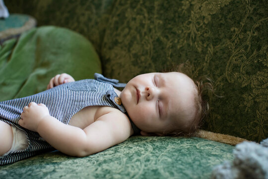 Close-up side view of a Baby Boy Sleeping on a Sofa