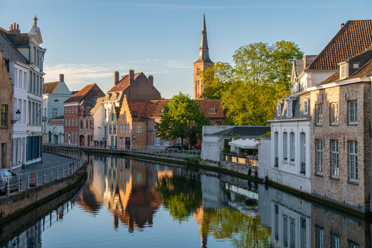 Evening view of historic houses reflected in a canal, Bruges, Belgium
