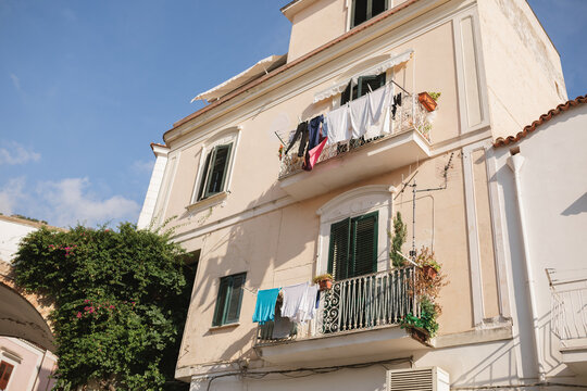 Low angle view of washing hanging on balconies outside traditional buildings, Cetera on the Amalfi Coast, Salerno, Campania, Italy