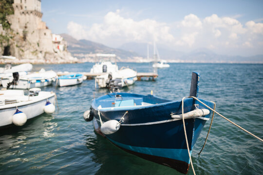Boats moored in the harbour in front of a Coastal townscape on the Amalfi coast, Cetara, Salerno, Campania, Italy