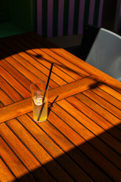 Passion fruit lemonade drink on a wooden table in sunlight