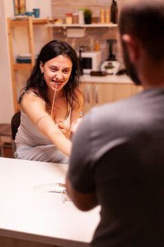 Desperate woman injects an illegal substance at home, showing syringe use, drug addiction, personal crisis and substance abuse risk.