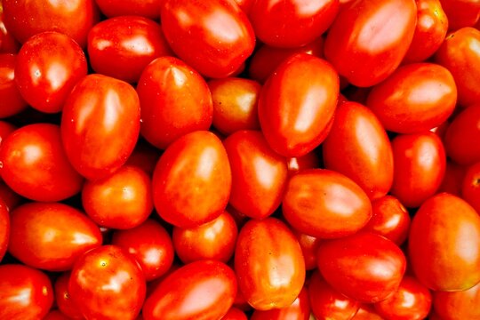 Full frame close-up of a stack of ripe plum tomatoes