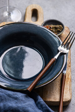 Overhead view of a rustic place setting on a wooden chopping board