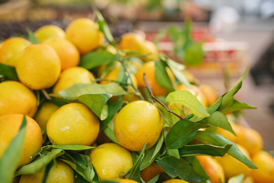 Close-up of a stack of fresh lemons at a market stall
