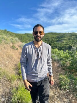 Hipster man wearing sunglasses walking along the Wild Rose Loop Trail, North Salt Lake, Salt Lake City, Utah, USA