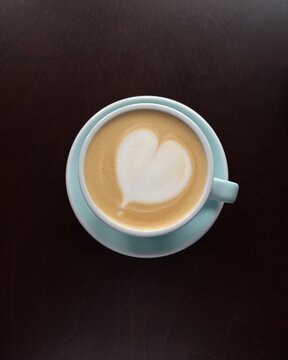 Overhead view of a latte coffee with heart shaped froth decoration