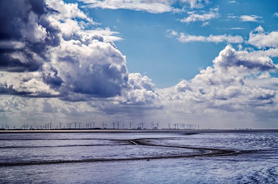 Mudflats in the Dollart river with a Distant view of wind turbines, East Frisia, Lower Saxony, Germany