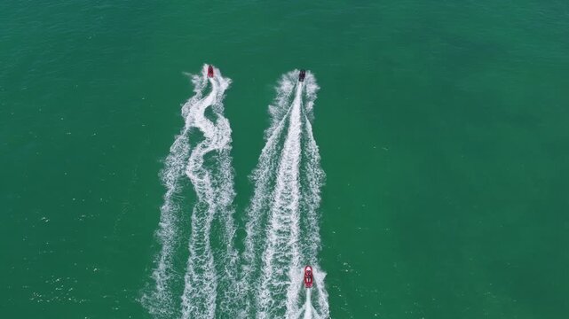 Beach life concept. Vacation on summer. Aerial view at vacation. Jet ski in motion. Summer vacation activity. Water sport activity in summer. Sea beach lifestyle