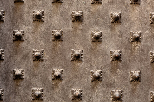 Close up detail of beautiful ornate metal door with metal studs, Genoa