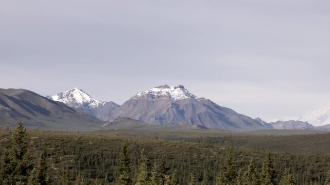 a panning long shot of mt mckinley during summer at alaska of the united states