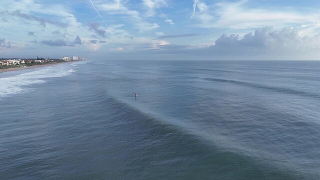 Stand up paddleboarding on a beautiful morning at Ormond Beach in Volusia County, Florida. 