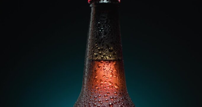 Close-Up Of Cold Beer Bottle With Condensation Droplets on the glass On Dark Background