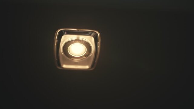 Hand turning on and off car interior dome light