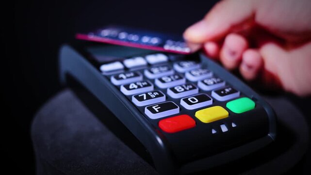 Hand Making Contactless Payment With Credit Card At Payment Terminal 
