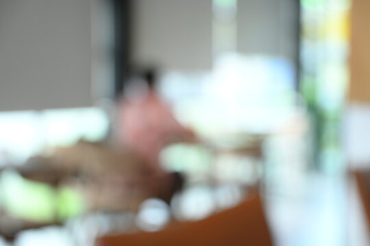 softy blurred view of a modern cafe or lounge interior featuring comfortable chair and round table