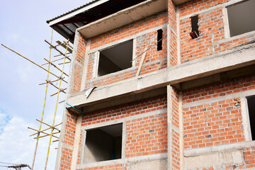 Obraz premium exterior view of brick house under construction with concrete structure
