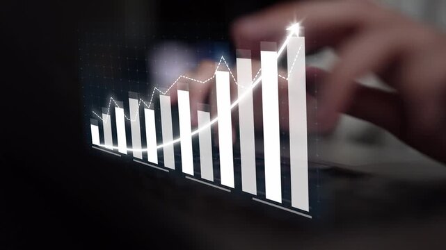 This image captures a modern workspace with a digital graph illustrating financial growth. It highlights analytics, trends, and productivity in business environments. Copula