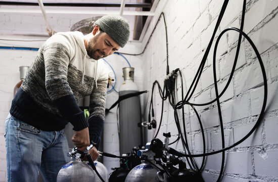 Asian diver man working inside filling station at diving workshop center