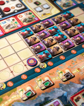 Portrait close up product photography of Great Western Trail components showing building tokens worker tokens and train pieces designed by Alexander Pfister and Chris Quilliams