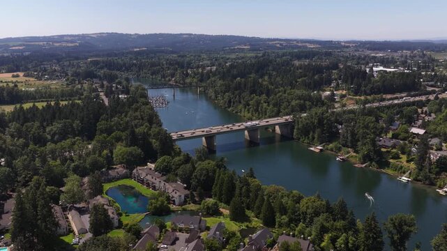 Aerial of Willamette River in residential area with Interstate 5 bridge in Wilsonville Oregon with marina and docked boats in summer