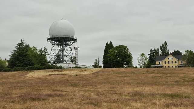 Radar dome on metal tower in Washington state field