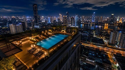 Fototapeta premium Night City Rooftop Infinity Pool Terrace With Luxury Lounge And Illuminated Skyline