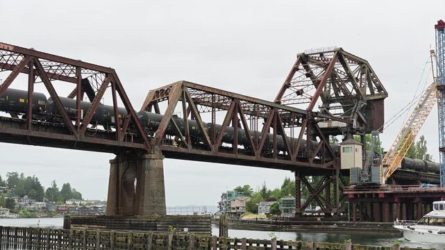 Train crossing Salmon Bay Bridge while boat passes below