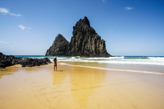 Person on the beach below the Dois Irmaos rocks, Fernando de Noronha, Pernambuco, Brazil