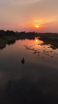Serene sunset river journey traditional boat silhouette golden hour reflection peaceful rural