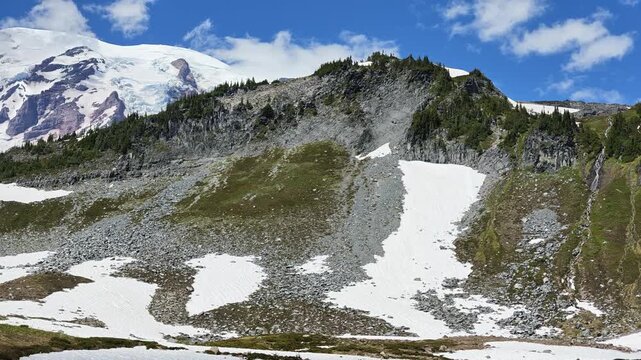 Panning shot of Mount Rainier snowfields and rocky slopes in Washington