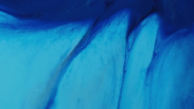 Ink dissolving. Hypnotic fluid. Blue liquid blotch blur stream floating abstract emulsion background. Dye splatter spread color dripping.