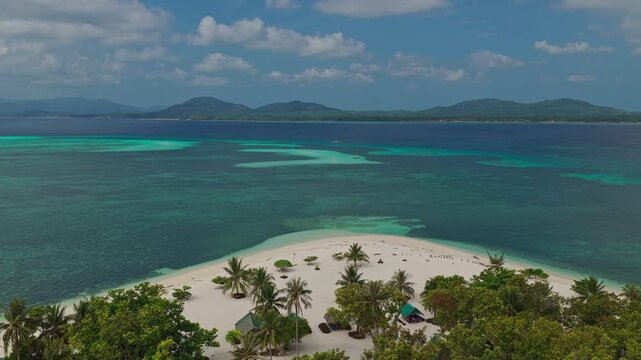 Aerial drone low altitude right to left orbit shot facing the sandbar along the coast of Bugsuk Island near Punta Sebaring in Balabac Palawan Philippines over shallow turquoise water