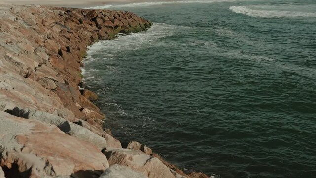 Waves Breaking Against a Stone Breakwater of Large Boulders Along the Coast at Ovar Portugal
