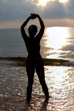 Woman with sunrise and silhouette