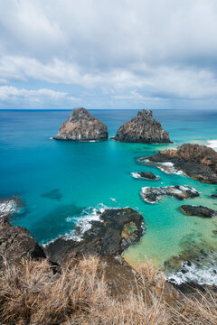 The Dois Irmaos rocks and the turquoise pools of Baia dos Porcos, Fernando de Noronha, Pernambuco, Brazil
