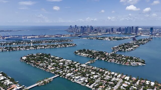 Aerial view of Miami skyline and waterfront islands over turquoise Biscayne Bay in sunny Florida, USA. g.