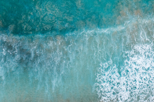 Aerial top view of turquoise ocean waves on the sand, Fernando de Noronha, Pernambuco, Brazil