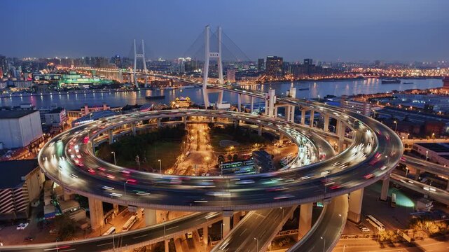 Cityscape day to night transition zoom in time lapse of Nanpu bridge illuminated at night with, with evening time rush hour commuters