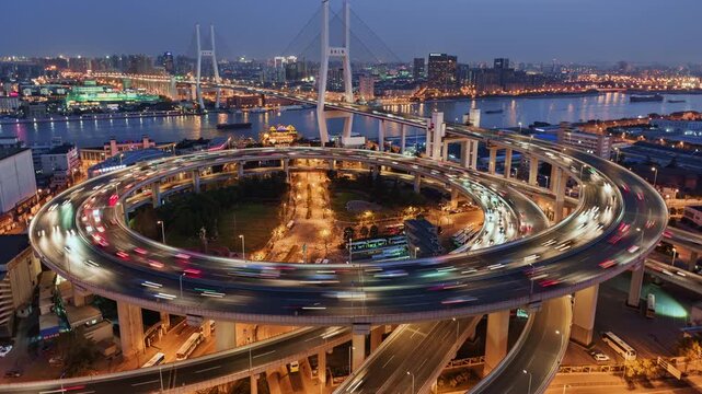 Cityscape day to night transition zoom out time lapse of Nanpu bridge illuminated at night with, with evening time rush hour commuters