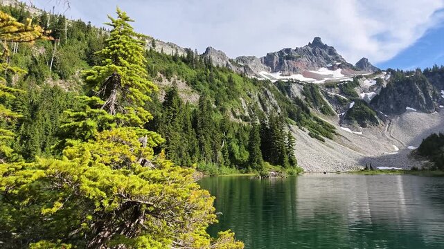 Snow-capped mountains and evergreens frame a Washington alpine lake