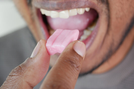 Man enjoys sweet pink gum in a relaxed moment