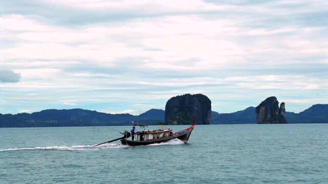 serene sailing across calm ocean waters with traditional wooden boat and rocky islands in the background, nature adventure travel visual story design resource web banner poster copyspace.