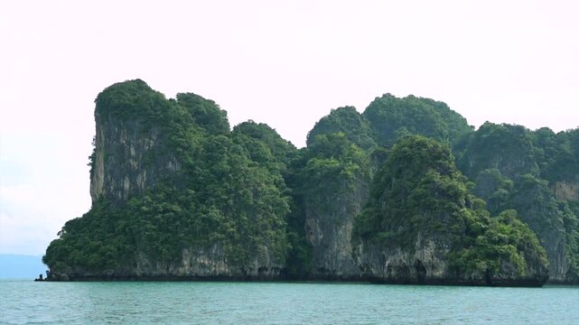serene stationary limestone cliffs overlooking ocean and sky with rocky texture and green-blue hues in fixed perspective for travel and tourism background design resource.