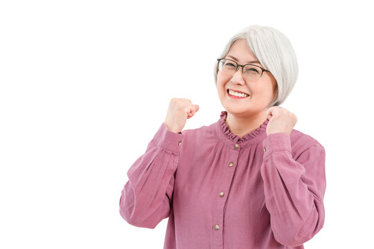 A smiling senior woman with gray/silver hair (making a victory pose, showing determination, fulfillment, and growth)
